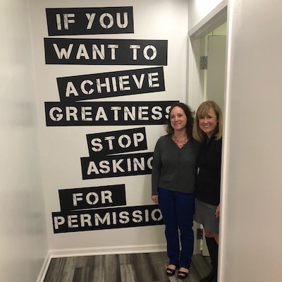 Two-women-standing-next-to-wall-quote-about-permission